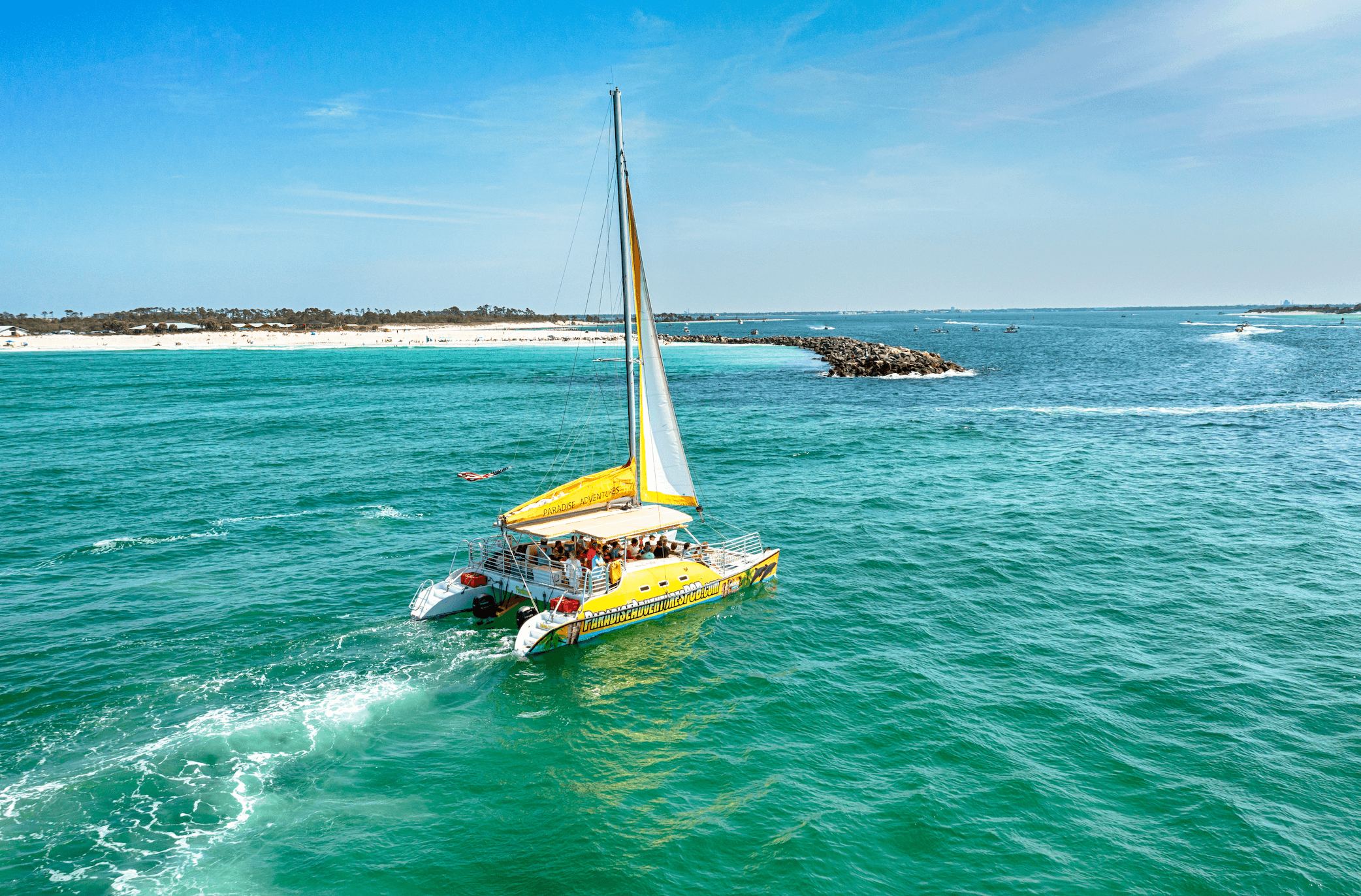 SV Footloose cruising through the pass near Shell Island jetty rocks
