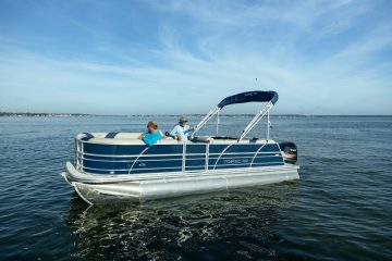 2 guests on a pontoon boat rental on the shores of Panama City Beach